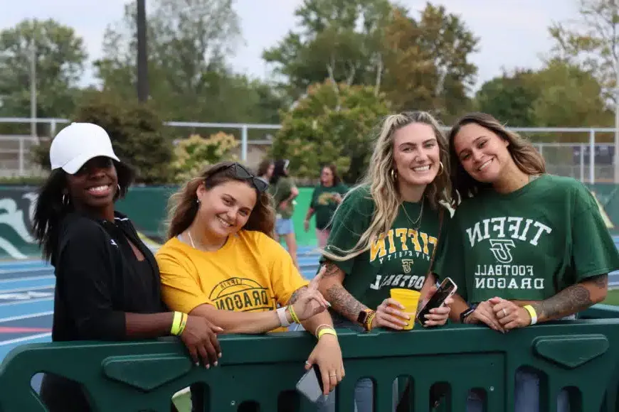 smiling alumni at football game